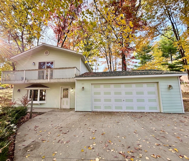 view of front of property featuring a garage and a balcony