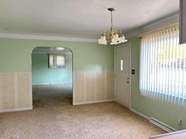 interior space featuring a baseboard heating unit and an inviting chandelier