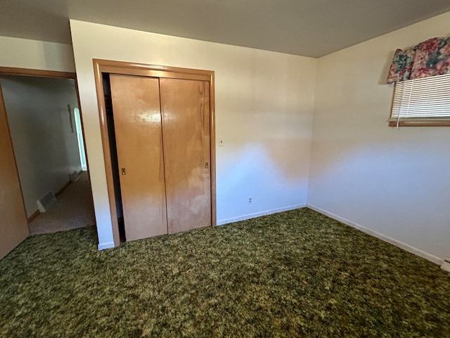 unfurnished bedroom featuring a closet and carpet floors