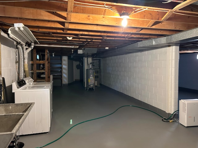 basement with sink, washing machine and dryer, and gas water heater