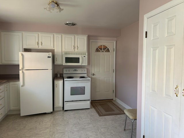 kitchen with white cabinets and white appliances