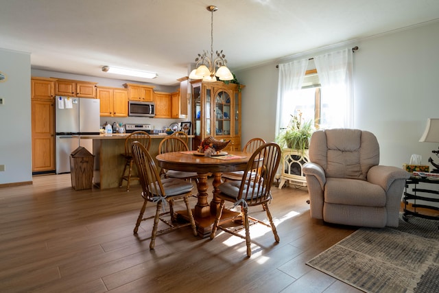 dining room with light hardwood / wood-style floors and a notable chandelier