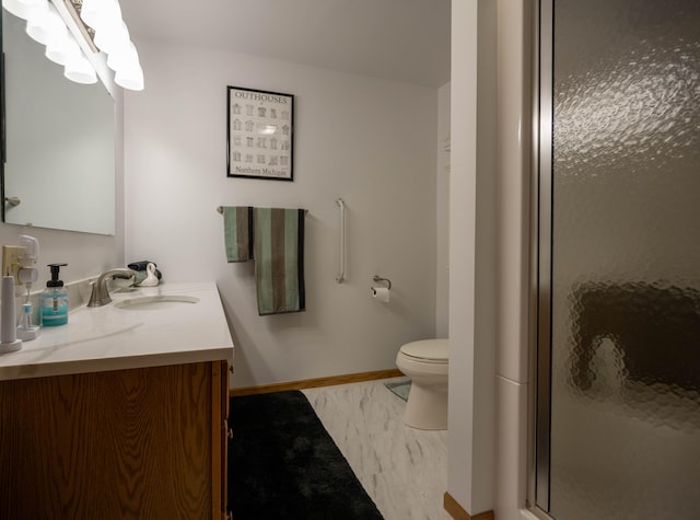 bathroom with vanity, toilet, and an enclosed shower