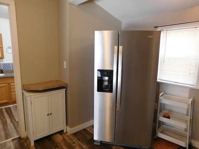 kitchen featuring stainless steel fridge with ice dispenser and dark wood-type flooring