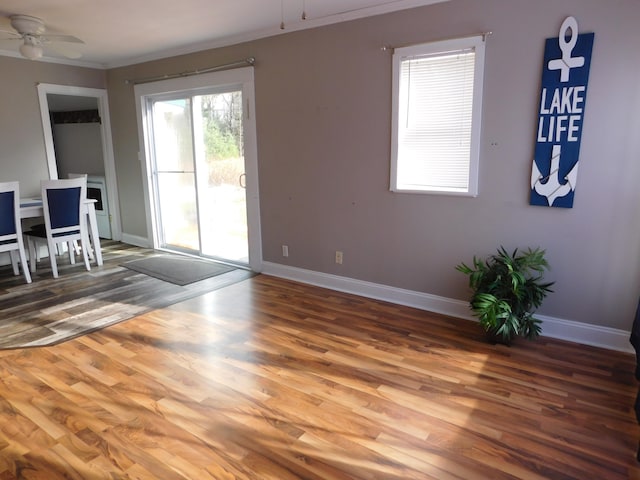 unfurnished room with ceiling fan, hardwood / wood-style floors, and crown molding