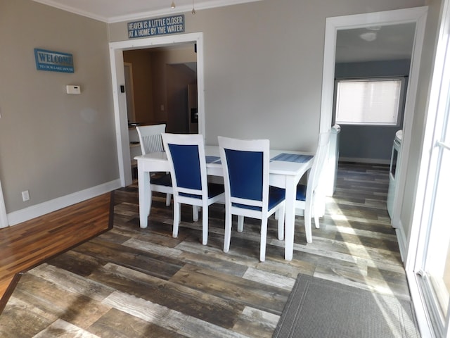 dining room with crown molding and dark hardwood / wood-style floors