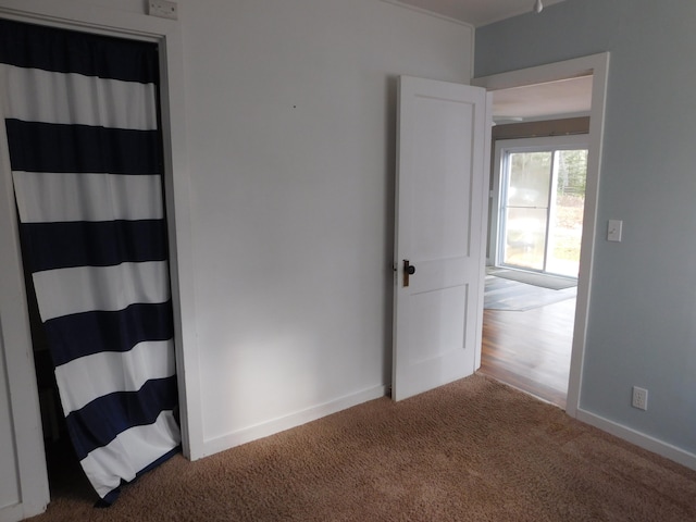 unfurnished room featuring carpet