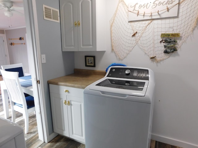 washroom with cabinets, dark hardwood / wood-style floors, ceiling fan, and washer / dryer