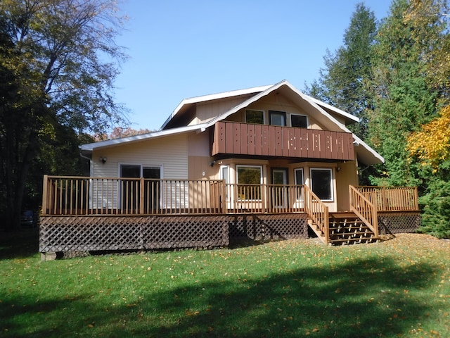 rear view of house featuring a yard and a deck