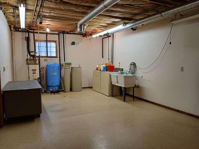 basement with sink, washer and dryer, and gas water heater