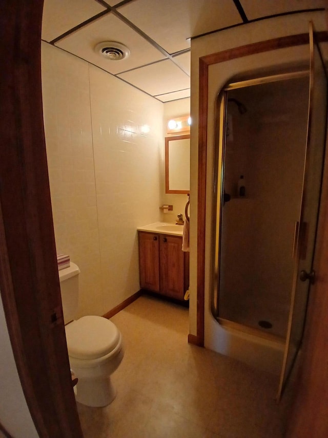 bathroom featuring walk in shower, vanity, and toilet