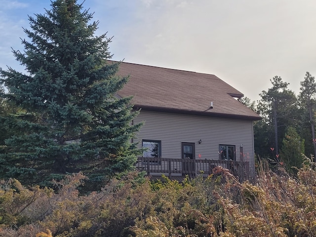 rear view of property featuring a wooden deck