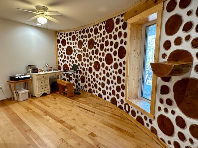 wine cellar featuring light hardwood / wood-style flooring and ceiling fan