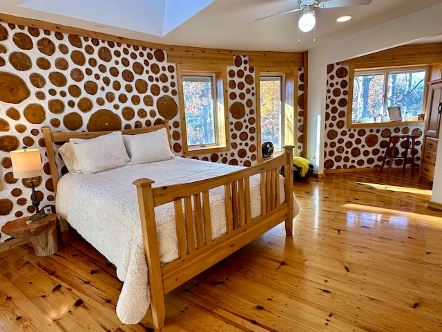 bedroom with light hardwood / wood-style floors and ceiling fan