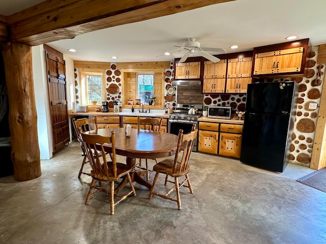 kitchen with black fridge, sink, tasteful backsplash, stainless steel range with gas stovetop, and ceiling fan