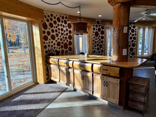 bar with pendant lighting and ceiling fan