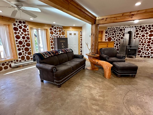 living room featuring beam ceiling, concrete flooring, a baseboard radiator, and ceiling fan