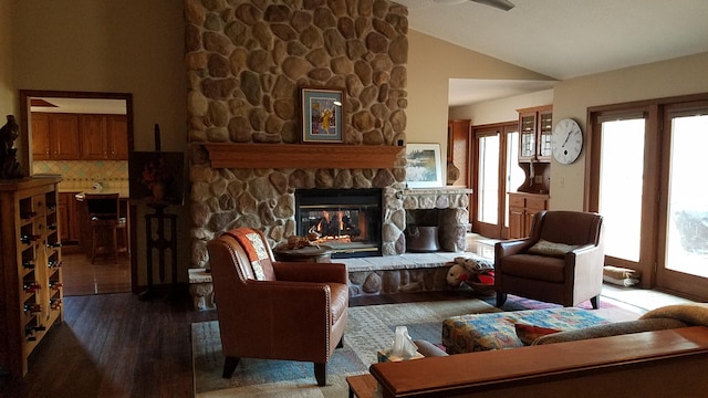 sitting room featuring lofted ceiling, a fireplace, and wood finished floors