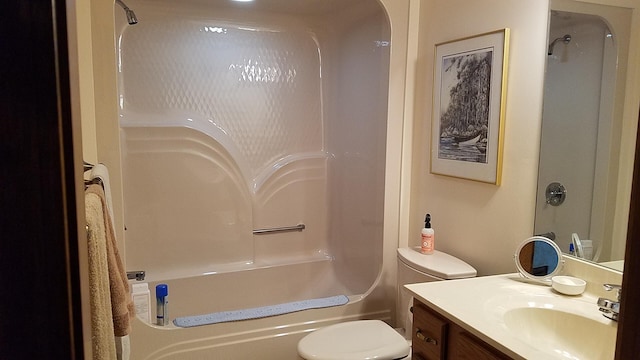 bathroom featuring shower / bathing tub combination, vanity, and toilet