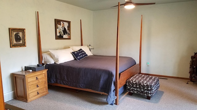 carpeted bedroom with ceiling fan and baseboards