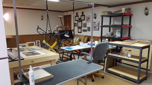 office space with wainscoting, crown molding, and wooden walls