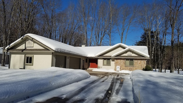 ranch-style house featuring a garage and a chimney