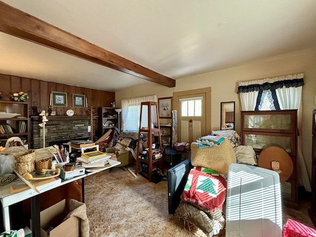 interior space featuring beam ceiling, wooden walls, and carpet flooring