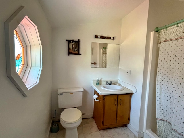 bathroom with vanity, lofted ceiling, a shower with shower curtain, and toilet