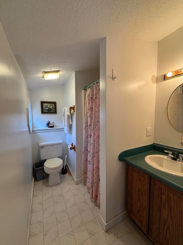 bathroom featuring vanity, a shower with curtain, a textured ceiling, and toilet