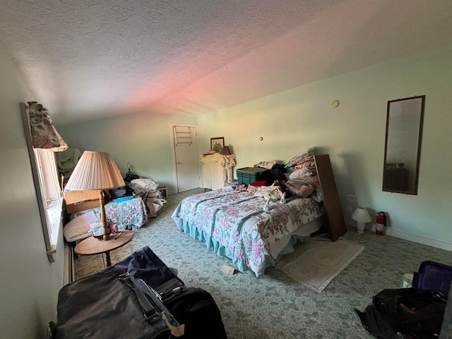 bedroom featuring a textured ceiling, carpet flooring, and vaulted ceiling