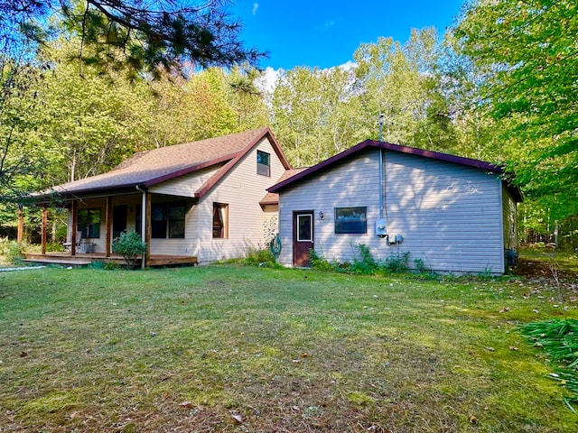 rear view of property with a lawn