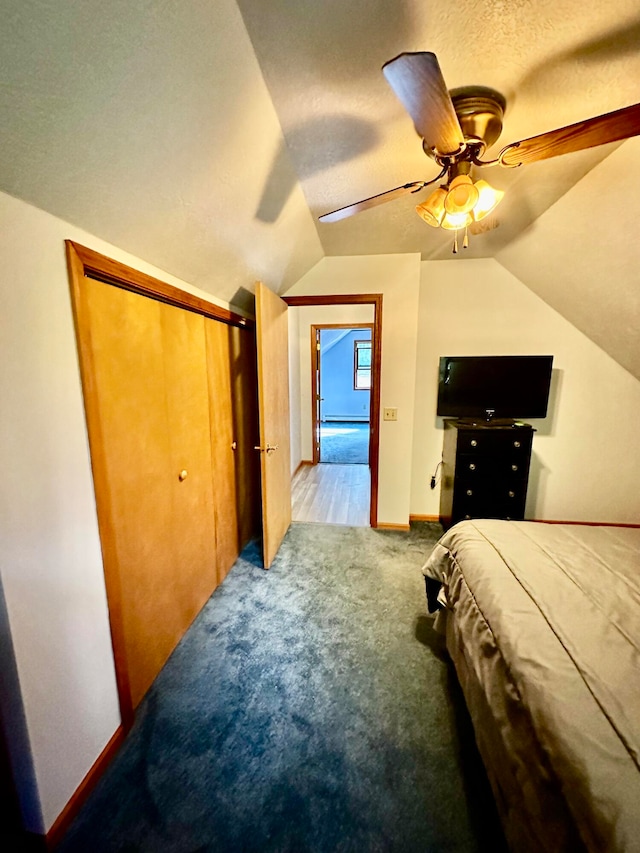 carpeted bedroom featuring a textured ceiling, lofted ceiling, ceiling fan, and a closet