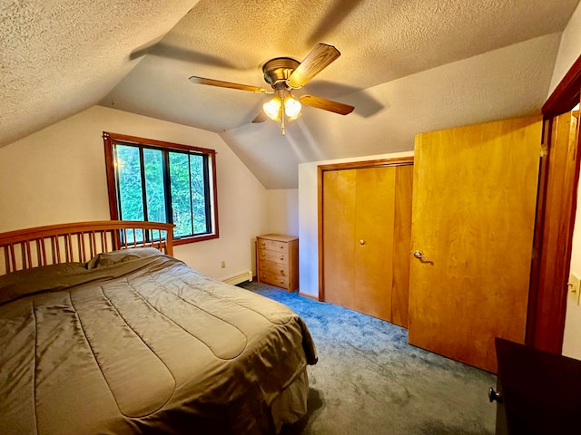 unfurnished bedroom with carpet flooring, vaulted ceiling, a textured ceiling, ceiling fan, and a closet