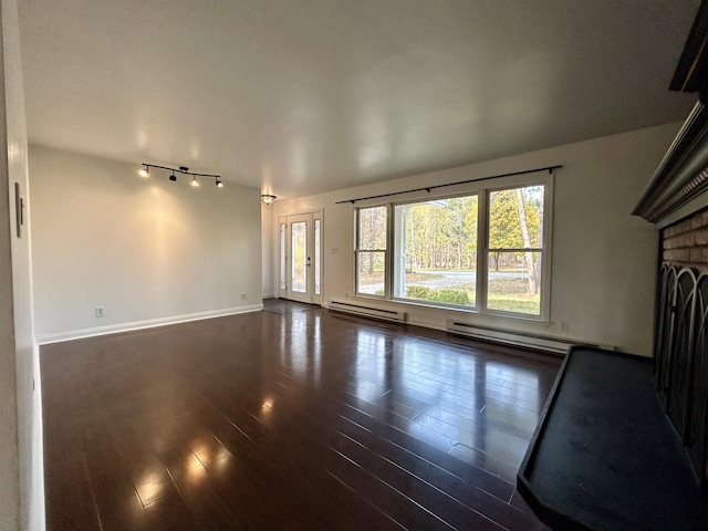 unfurnished living room featuring a baseboard radiator, a brick fireplace, and dark wood-type flooring