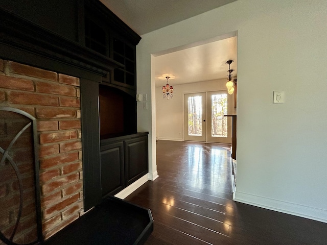 corridor with dark wood-type flooring and french doors