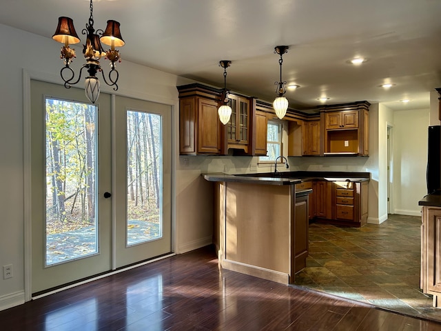 kitchen with decorative light fixtures, dark hardwood / wood-style flooring, french doors, and a chandelier