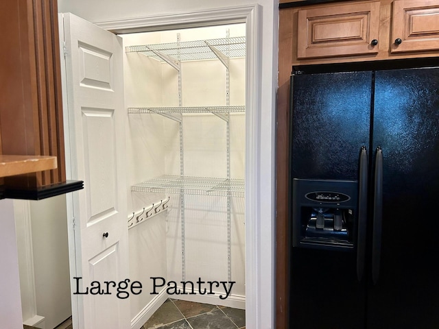 spacious closet featuring dark tile patterned floors