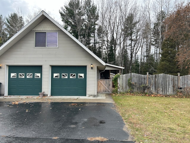 view of side of home featuring a garage and a yard