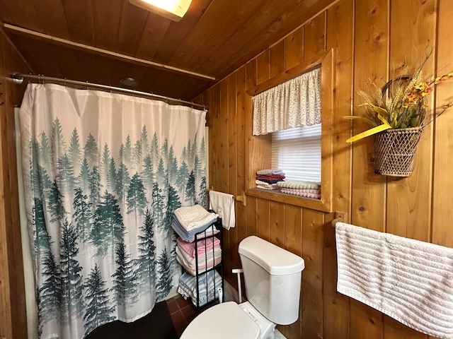 bathroom featuring a shower with shower curtain, wooden walls, toilet, and wood ceiling