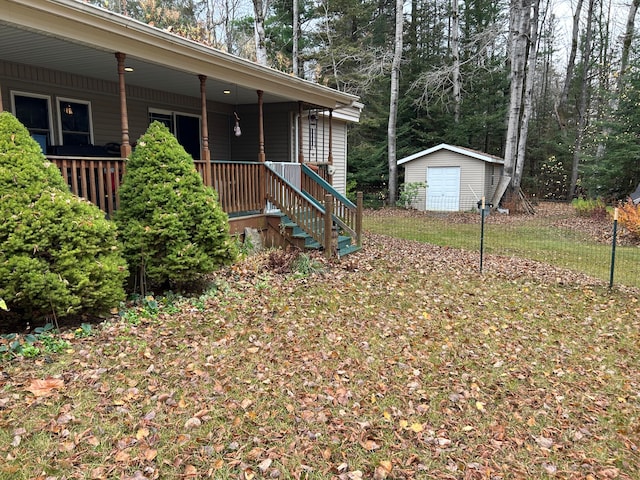 view of yard with covered porch and a storage shed