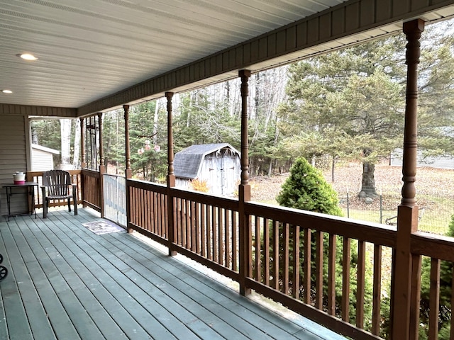 wooden deck with a storage shed