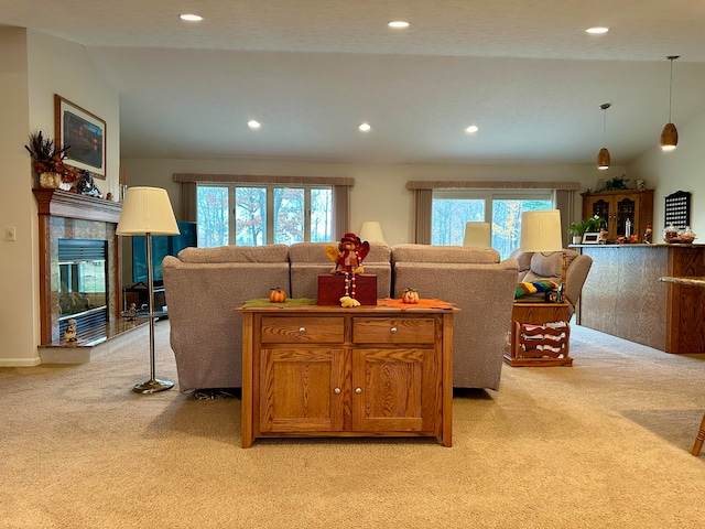 carpeted living room featuring lofted ceiling and a healthy amount of sunlight