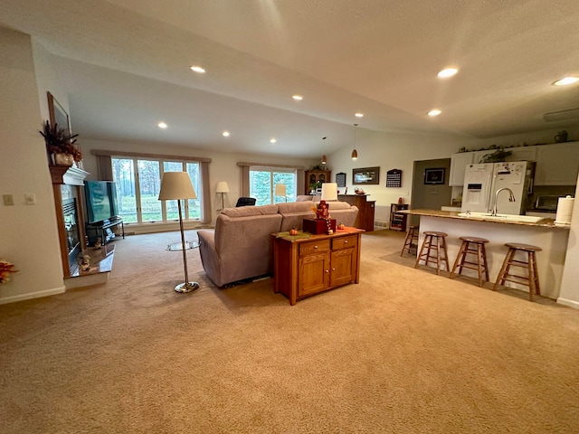 carpeted living room featuring lofted ceiling