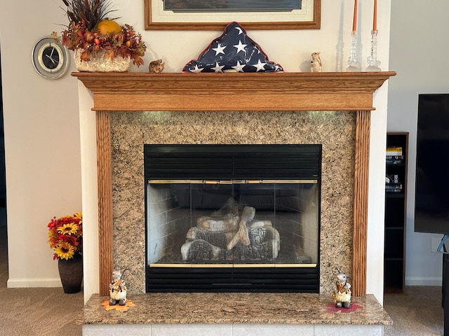 details featuring a high end fireplace and carpet flooring