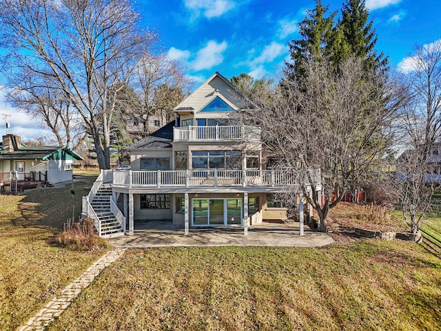 rear view of property with a lawn, a patio, and a deck