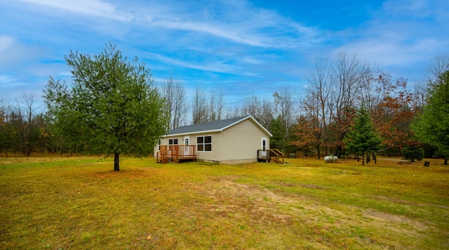 view of side of home featuring a deck and a yard