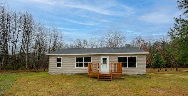 rear view of house with a yard