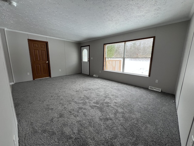 unfurnished living room featuring carpet floors, crown molding, and a textured ceiling