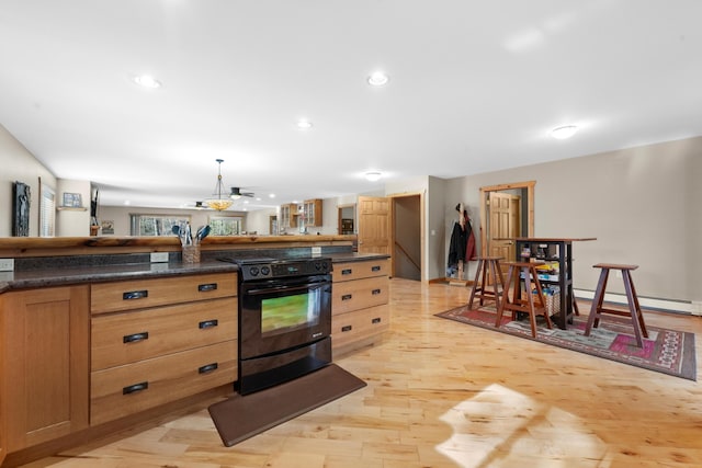 kitchen with light hardwood / wood-style flooring, a baseboard heating unit, hanging light fixtures, and black electric range