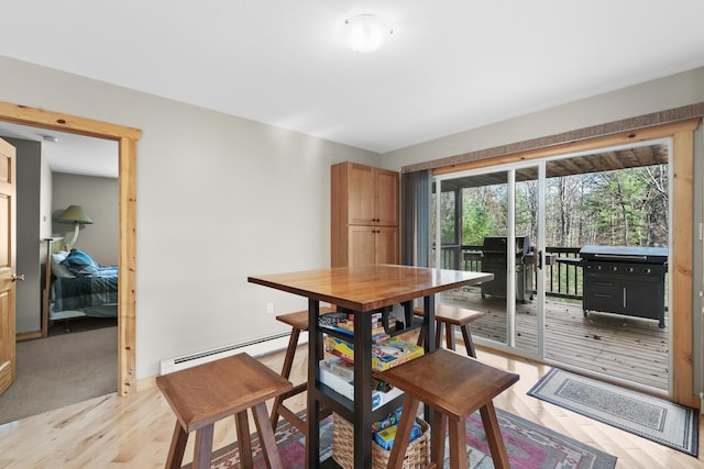 dining area with baseboard heating and light wood-type flooring